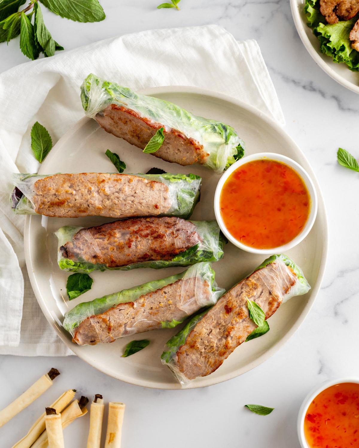 looking down on a plate of vietnamese grilled pork spring rolls