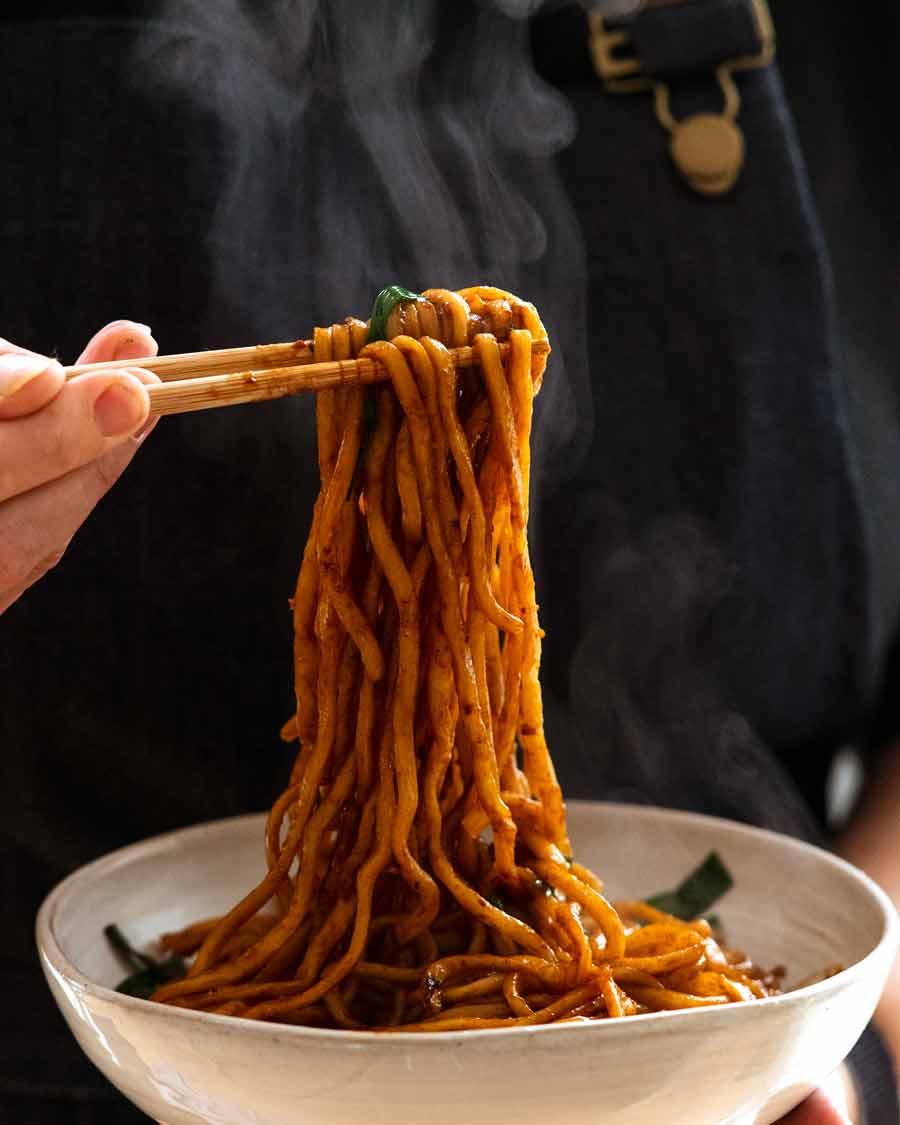 Chopsticks picking up Supreme Soy Noodles